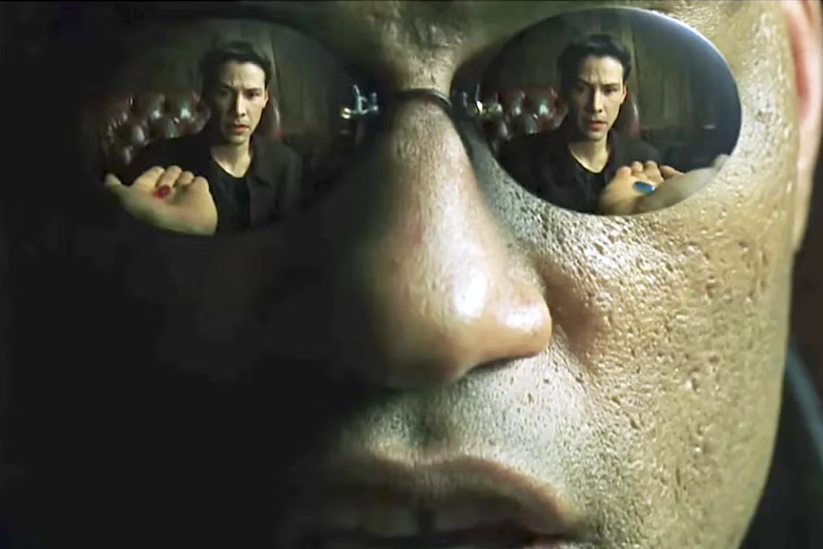 Neo reflected in Morpheus' sunglesses.
