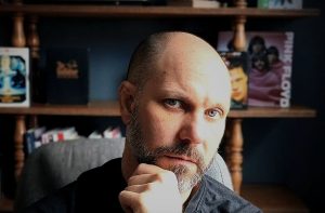 Mike Lind real estate agent analyzing home buying decisions with a thoughtful expression