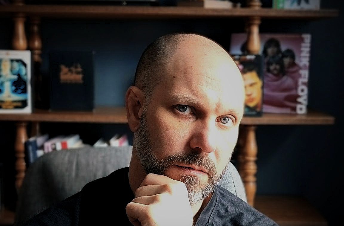 Mike Lind real estate agent analyzing home buying decisions with a thoughtful expression